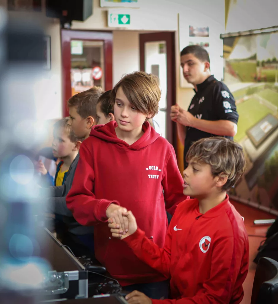 Twee deelnemers schudden elkaar de hand tijdens een FIFA toernooi bij AFC